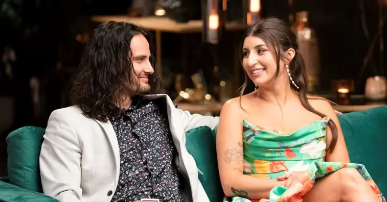 married at first sight jesse burford claire nomarhas smiling at each other at a commitment ceremony